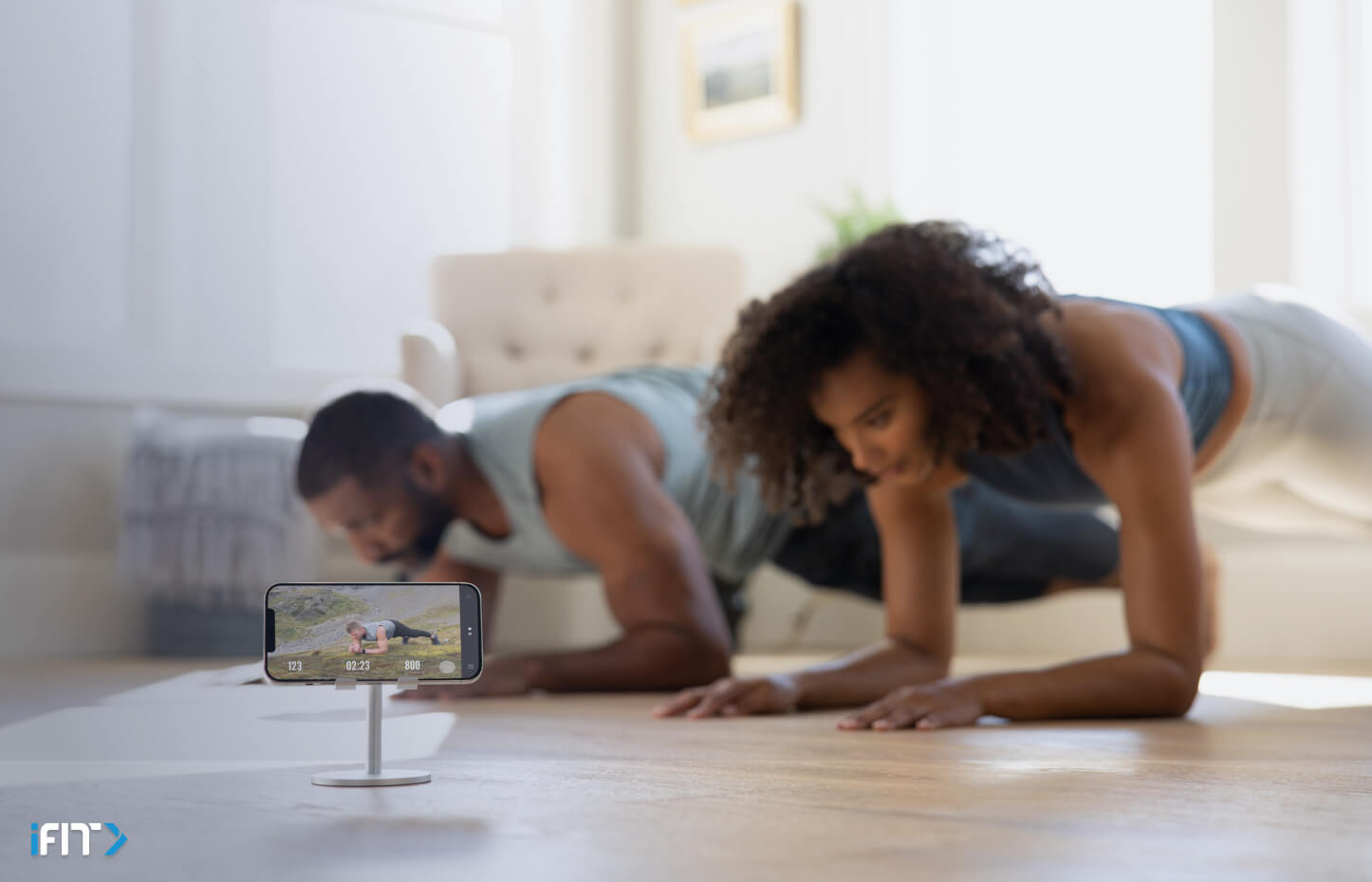 Couple does planks during a bodyweight workout