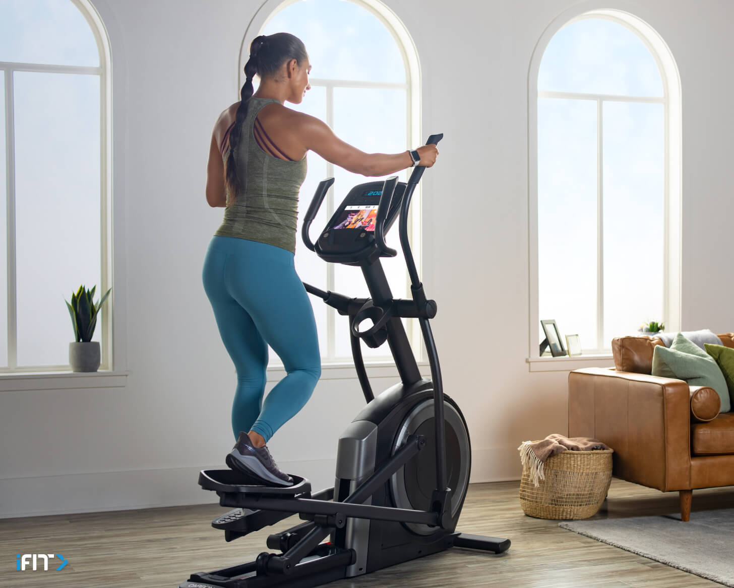 Woman completes iFIT elliptical workouts Woman does iFIT elliptical workouts