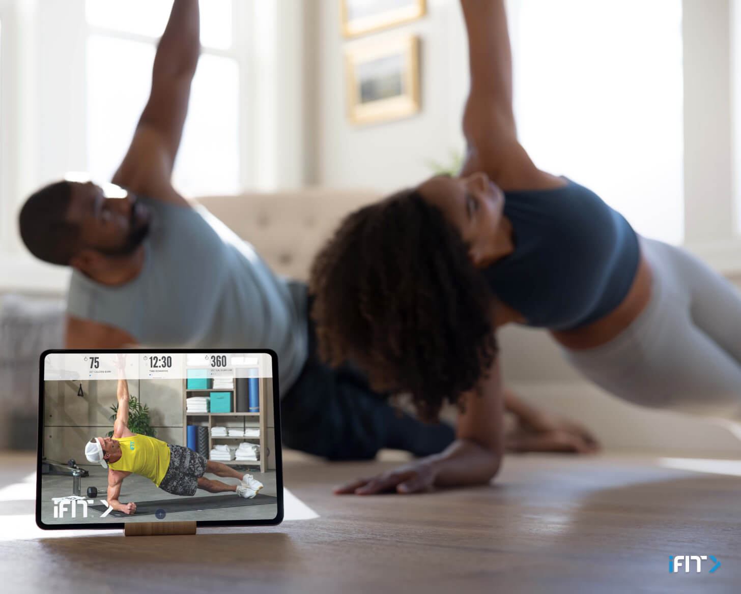 Woman does an iFIT full body exercise during a workout