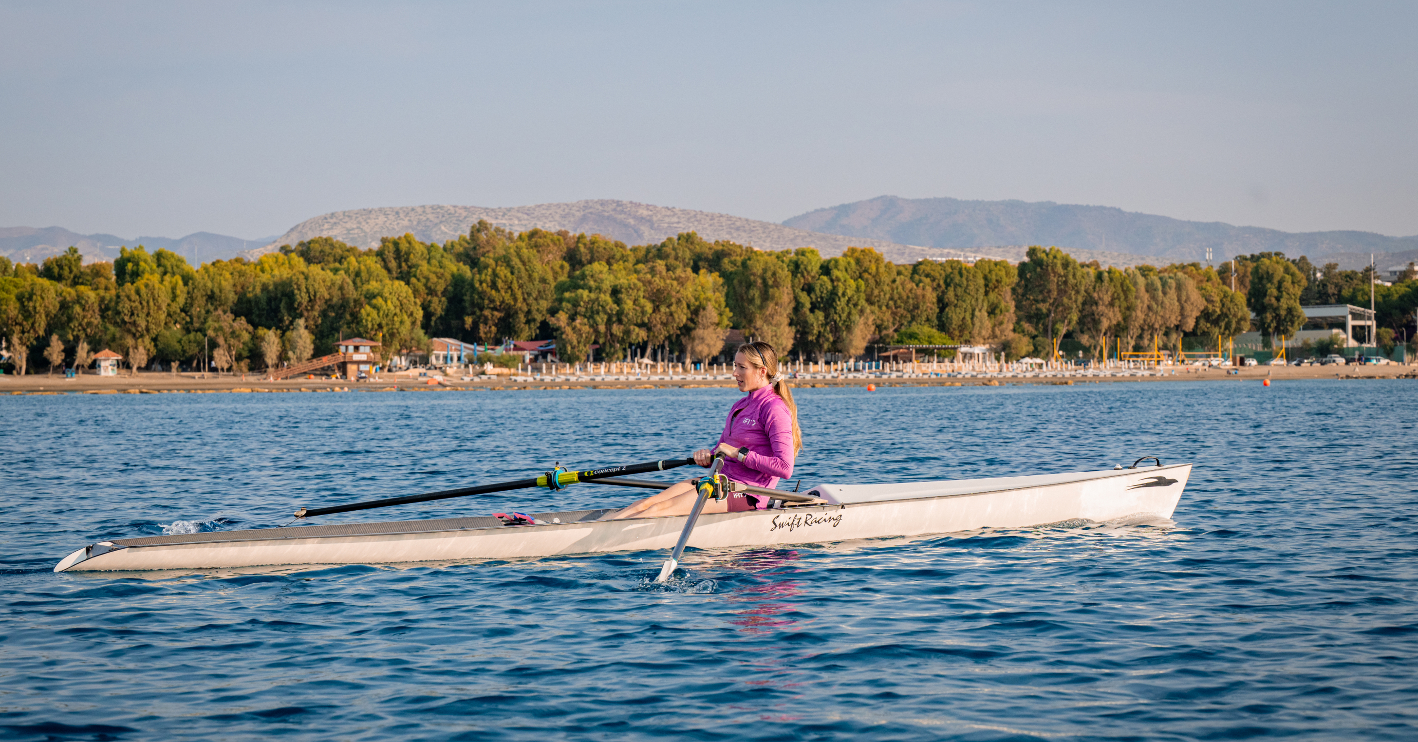 Follow a rowing workout in a fitness app with Laine Karwoski in Cyprus. Build endurance and full-body strength with guided training on the water.