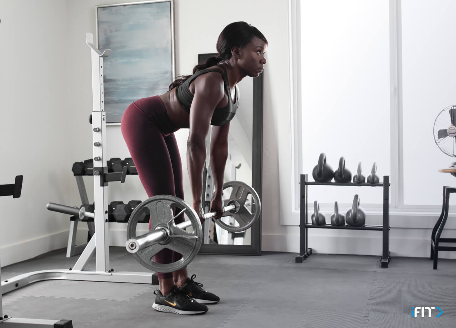 Woman completes an iFIT lower body exercise Woman does an iFIT lower body exercise