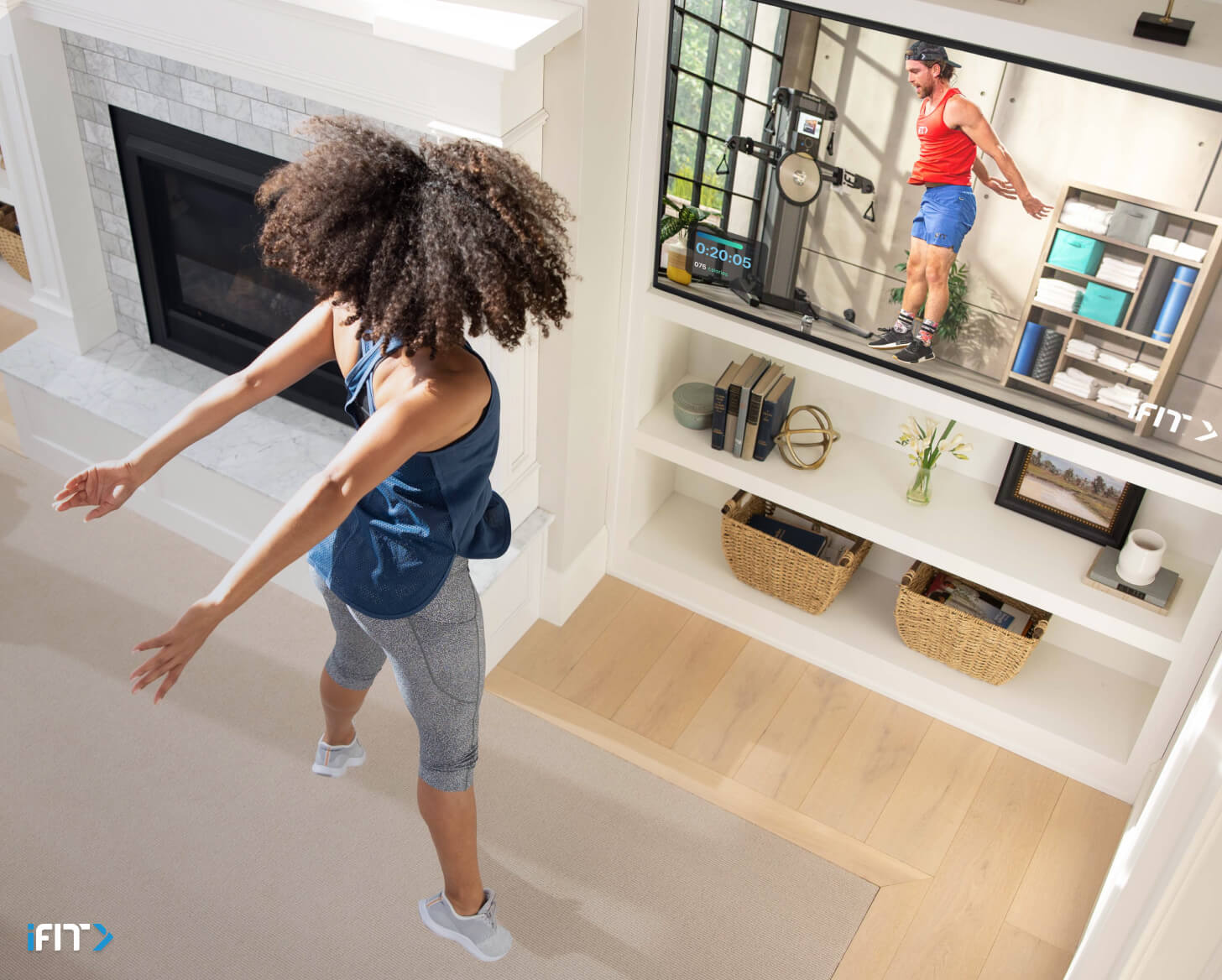 Woman does an iFIT bodyweight exercise Woman works out to an iFIT bodyweight exercise