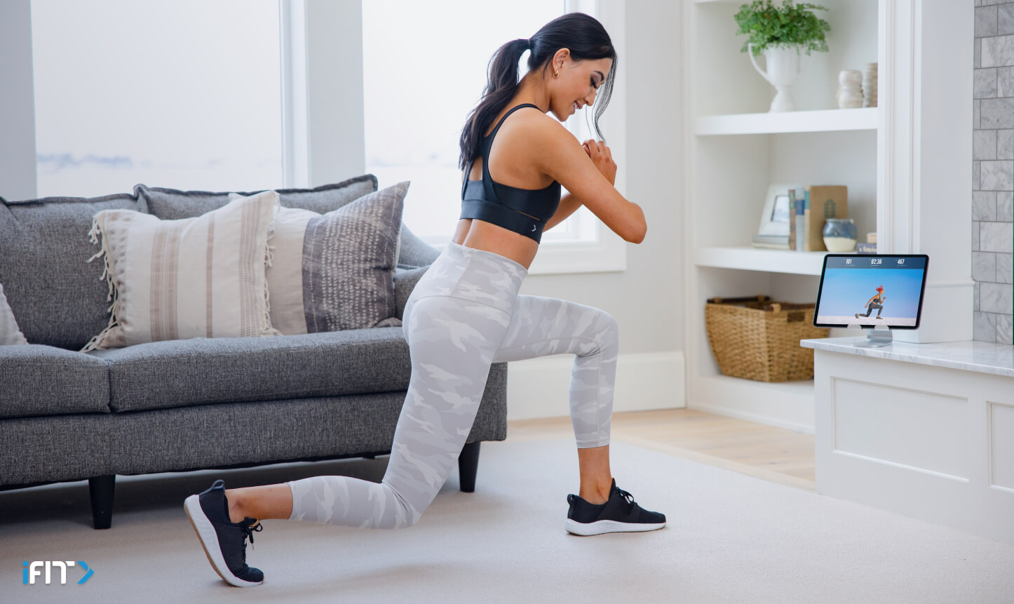 Woman completes an iFIT bodyweight workout Woman completes iFIT bodyweight exercises