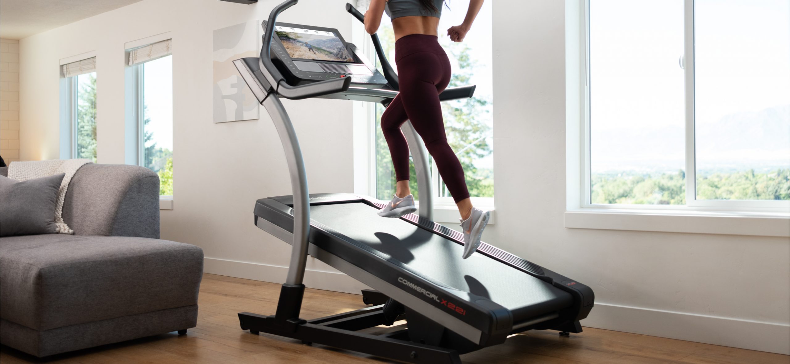 Woman uses the SmartAdjust feature during a running workout on her iFit-connected treadmill Woman uses SmartAdjust during a running workout on her iFit-connected treadmill