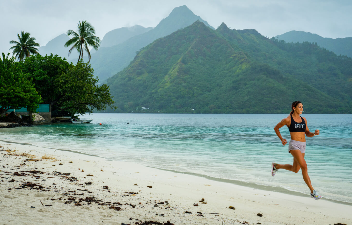 iFit Earth Day workout series iFit trainer coaches a beach running workout