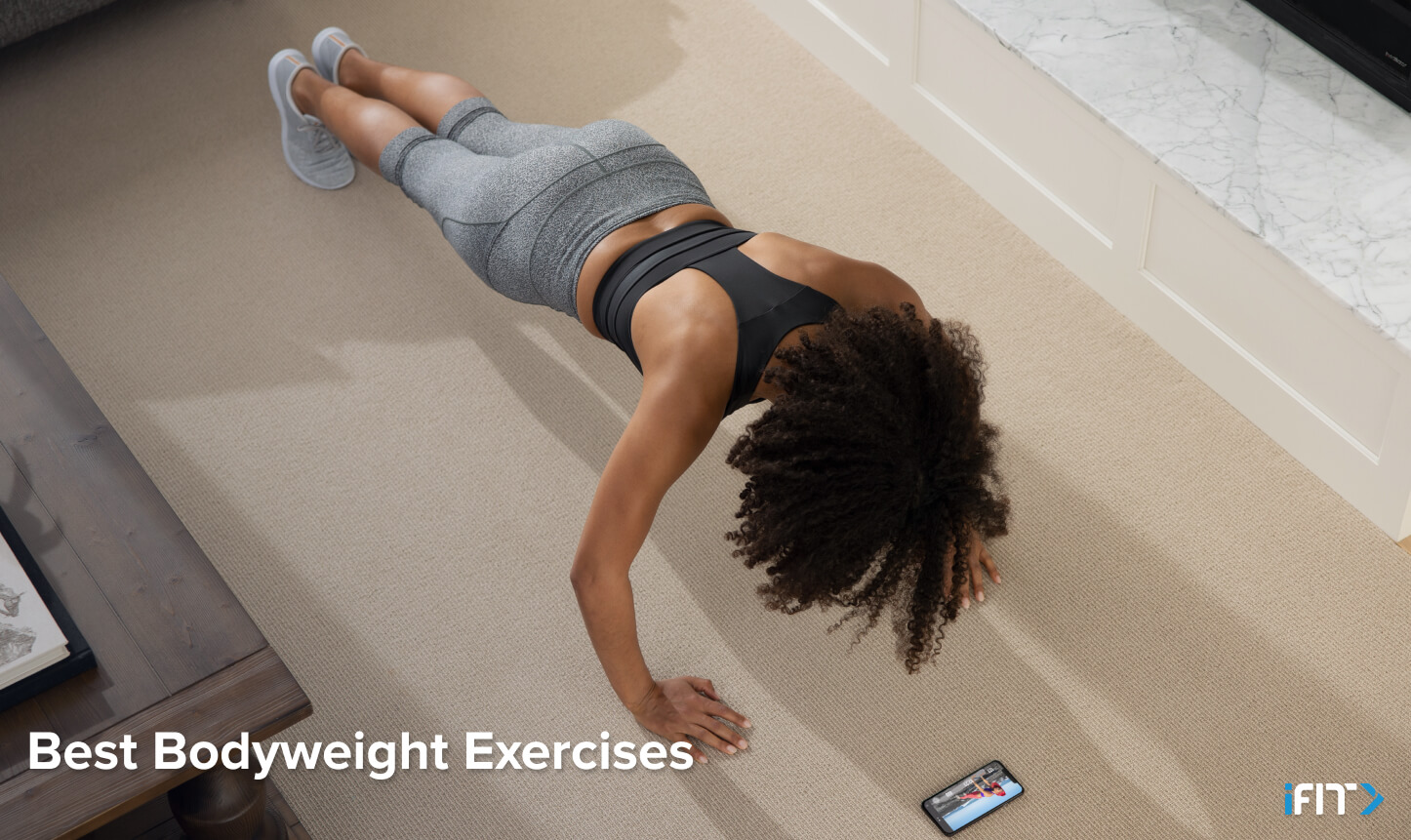 Woman does a pushup during her bodyweight class