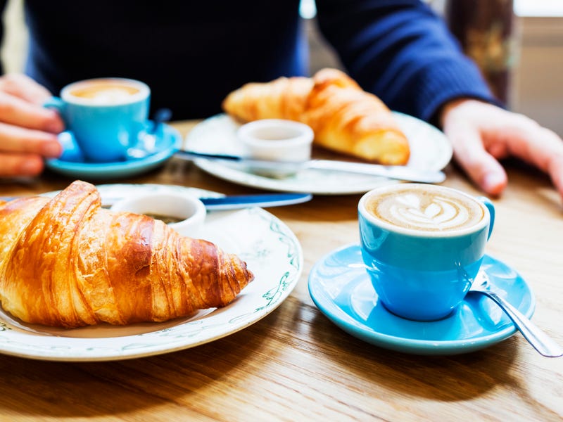 Croissants und Kaffee stehen auf einem Tisch bereit
