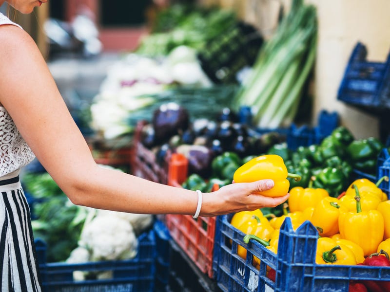 Woman buing vegetables.