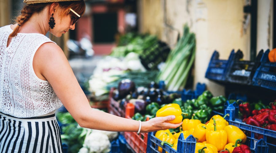 Woman buing vegetables.