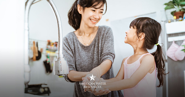 mother and daughter washing hands