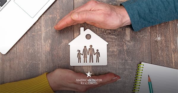 hands hovering around drawing of a home