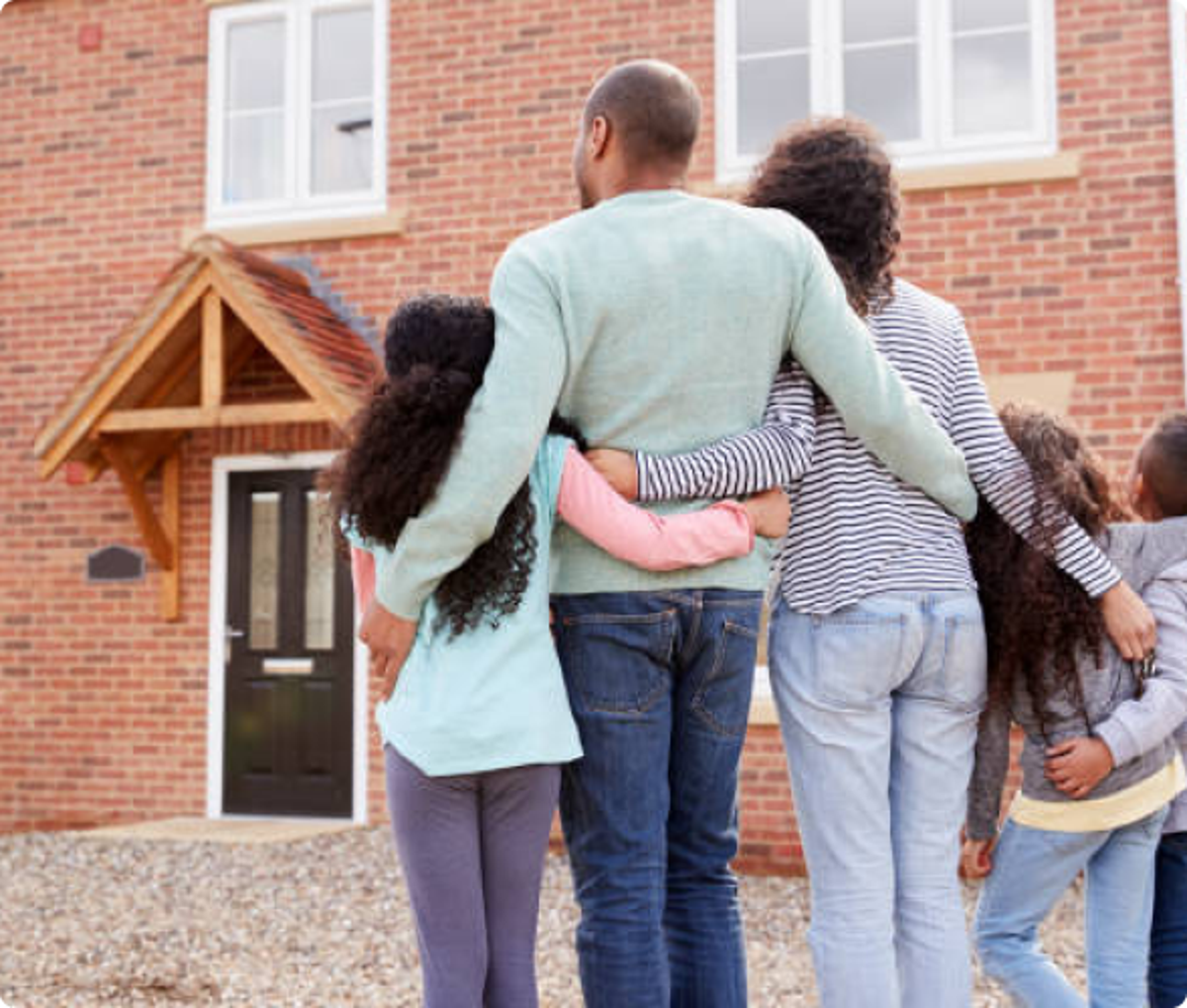 family standing in front of home