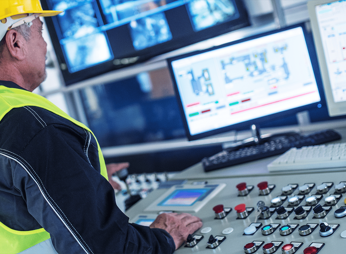 Person In a Control Room Surrounded By Monitors
