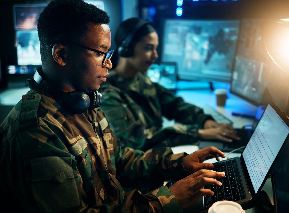 Two Soldiers in Dark Room Using Computers