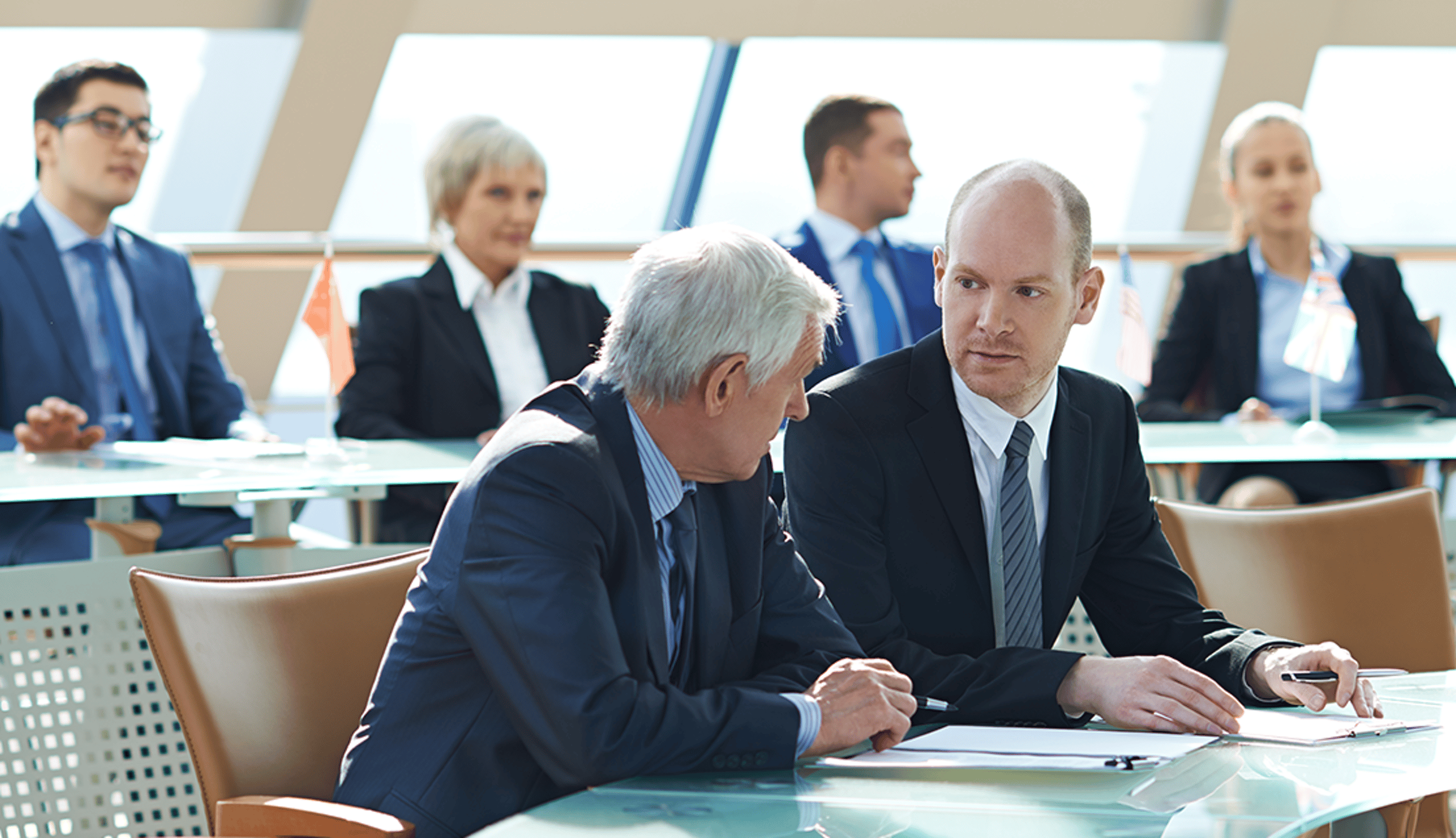 Two People in Suits Having a Serious Discussion