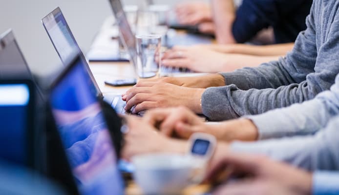 Close Up of Hands Using Laptops
