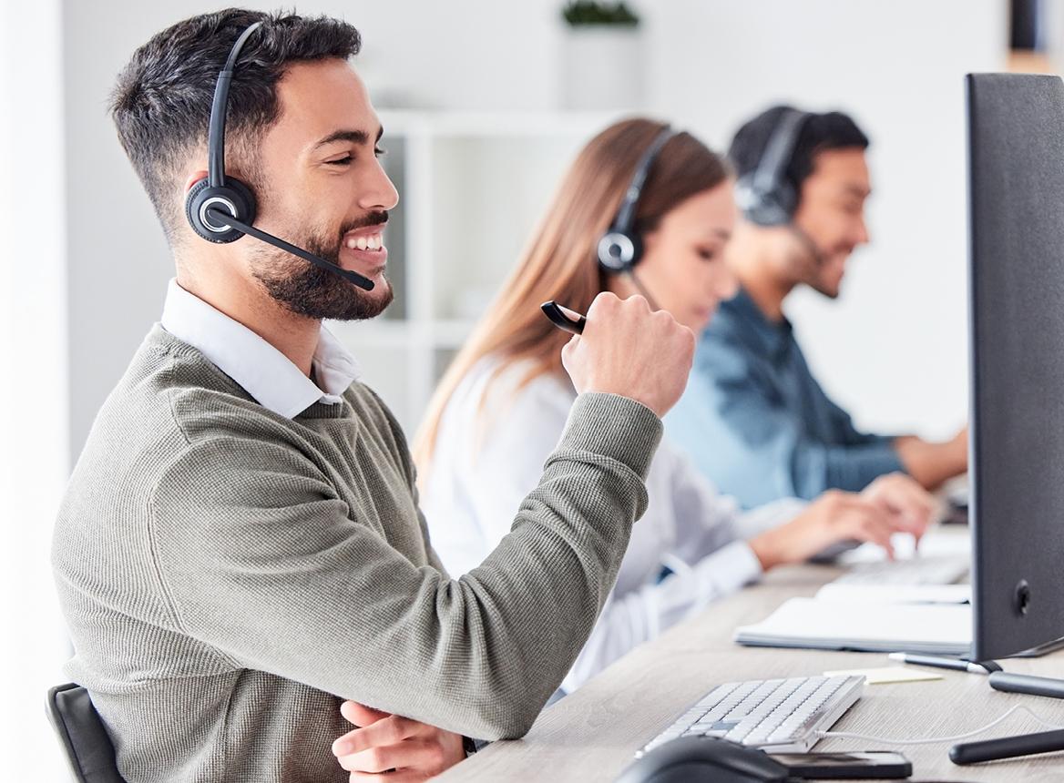 Three Customer Service People Wearing Headsets