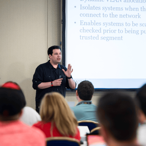 Bryan Simon: Teacher Standing Next to Smartboard and Explaining Concept