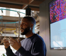 Man lecturing in front of board