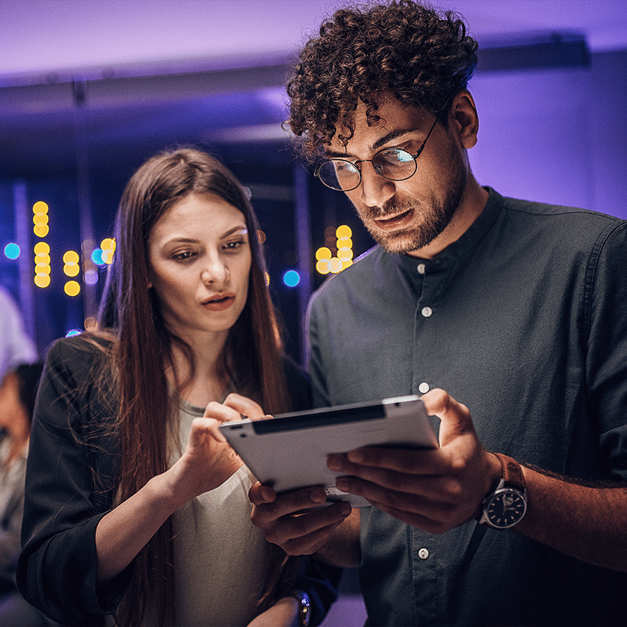 Two People Looking Intensely at an IPad