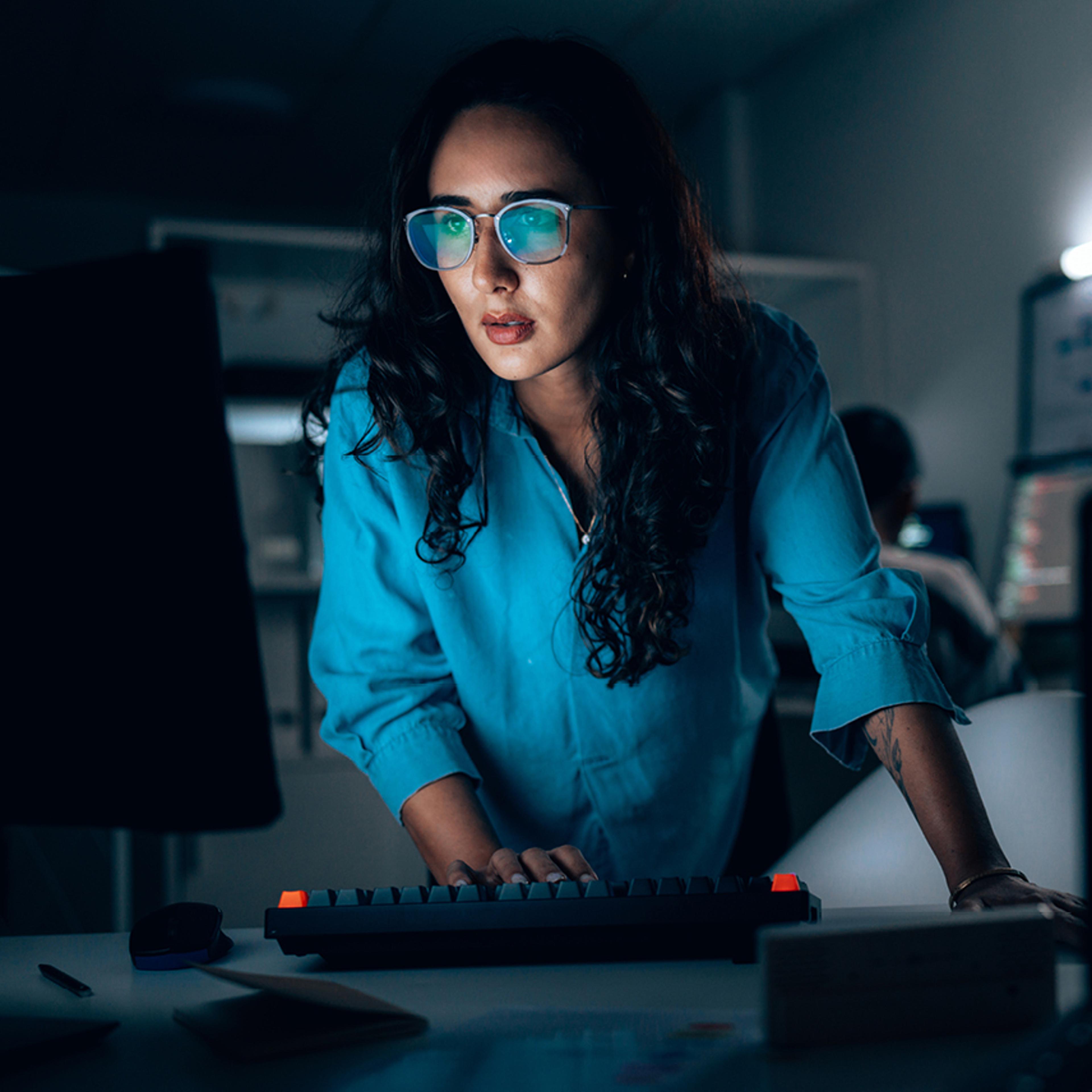 Woman Typing Looking at Computer Monitor