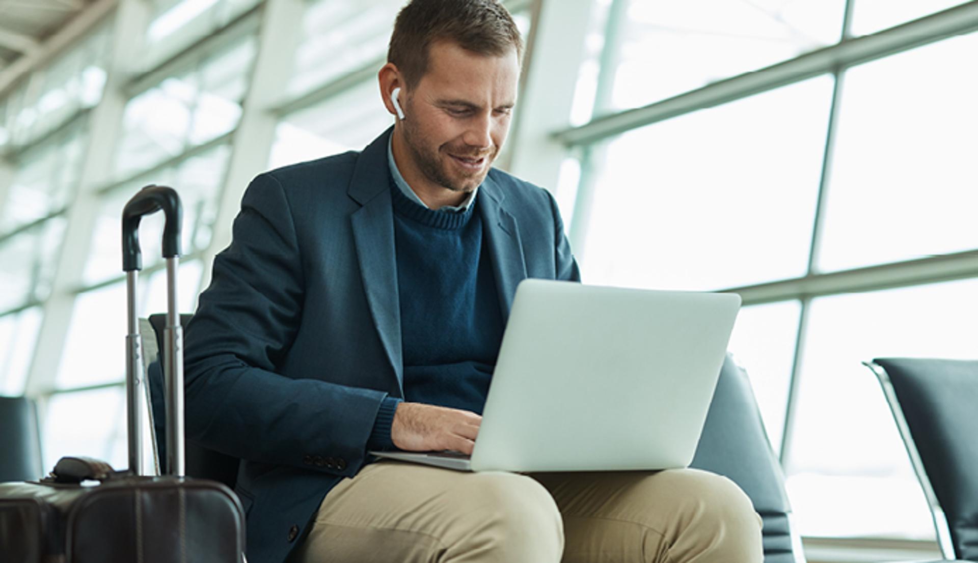 Man Using a Computer and Wearing Headphones