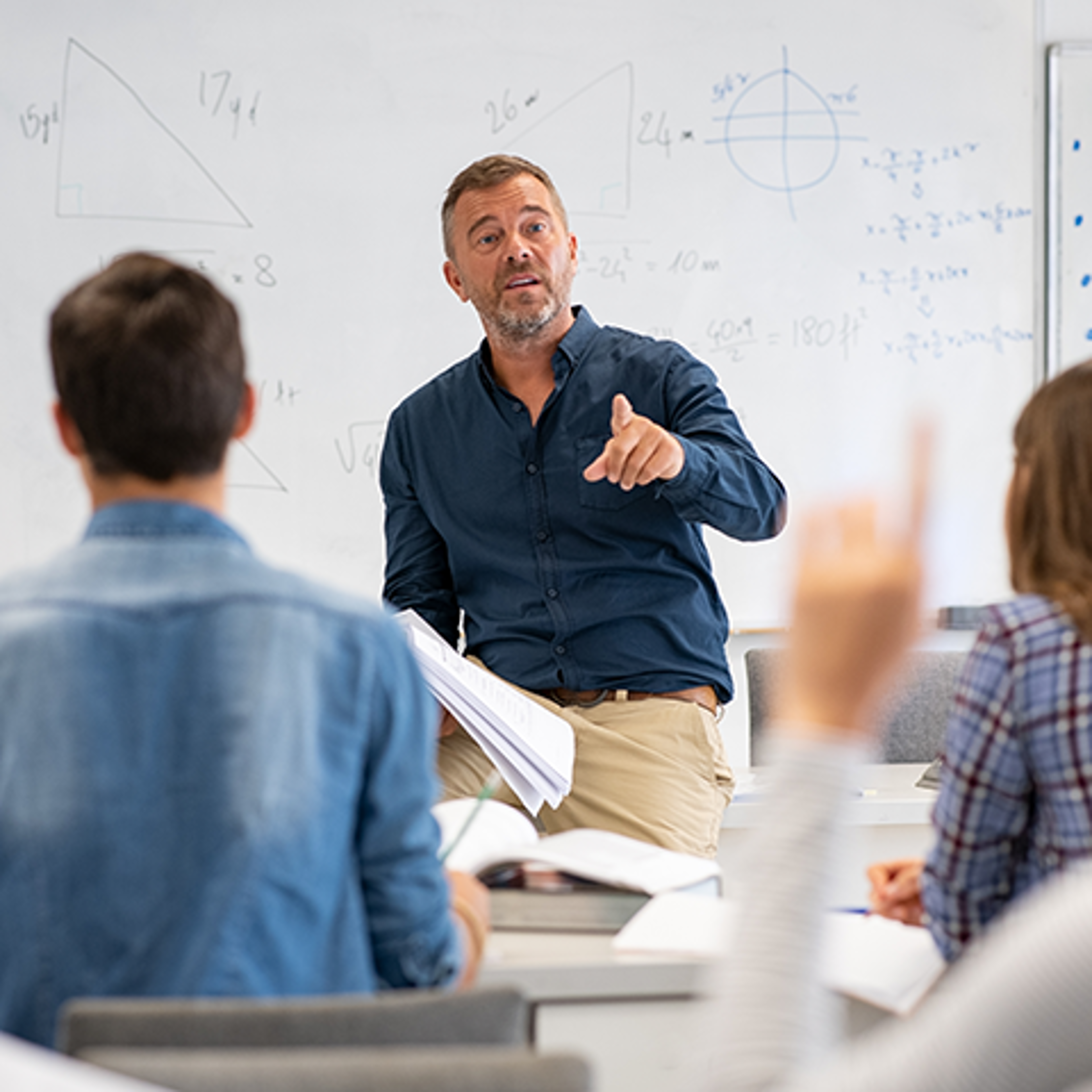 A Teacher Raising One Finger to Make a Point