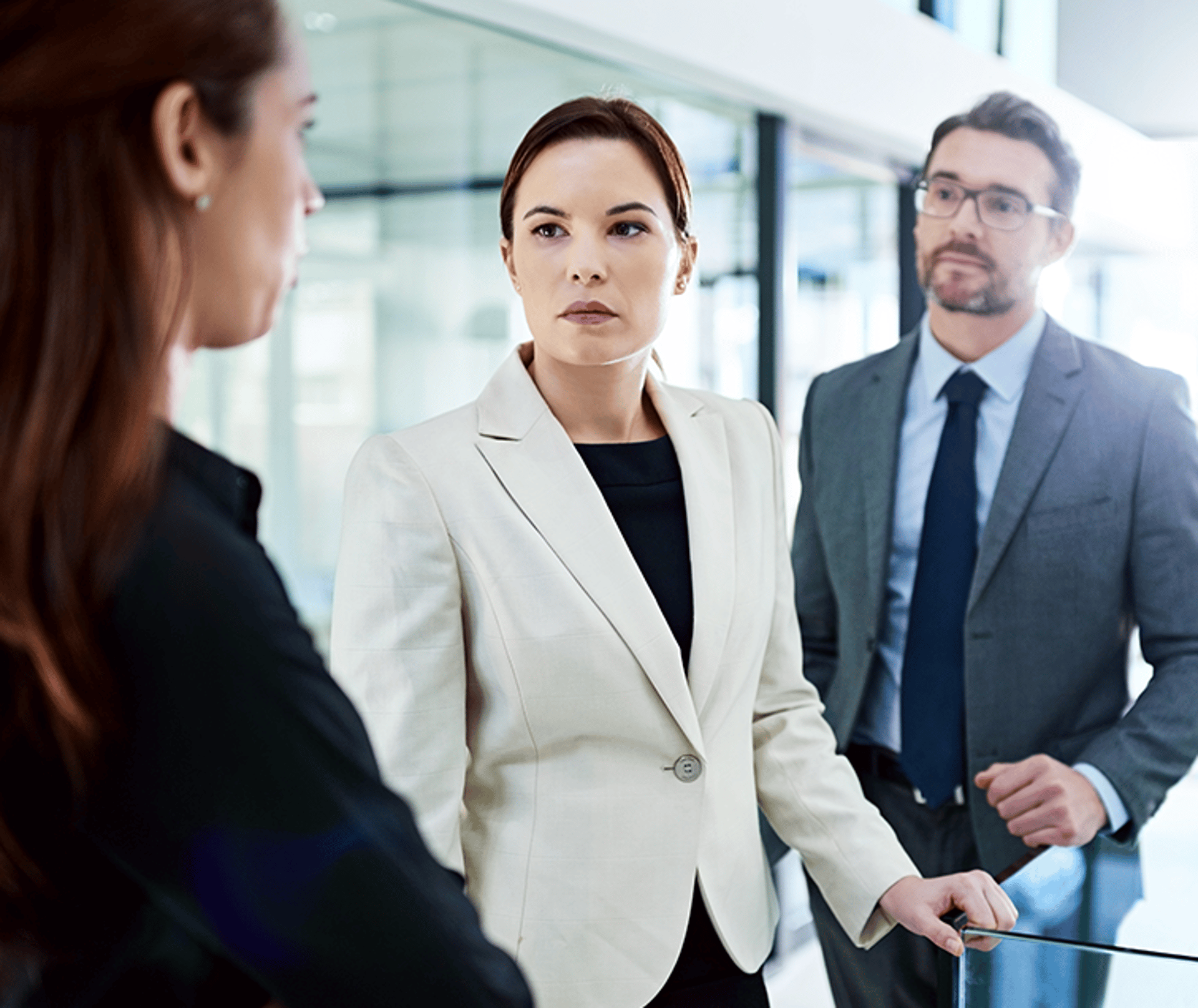Three Suited People Looking Very Serious