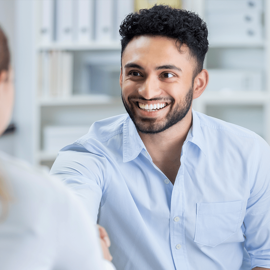 Smiling Man Shaking Hands With Someone Off Screen