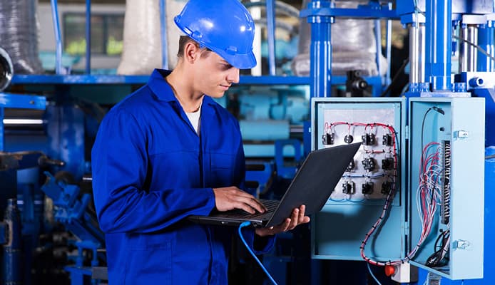 Man in Industrial Setting Wearing All Blue Protective Gear