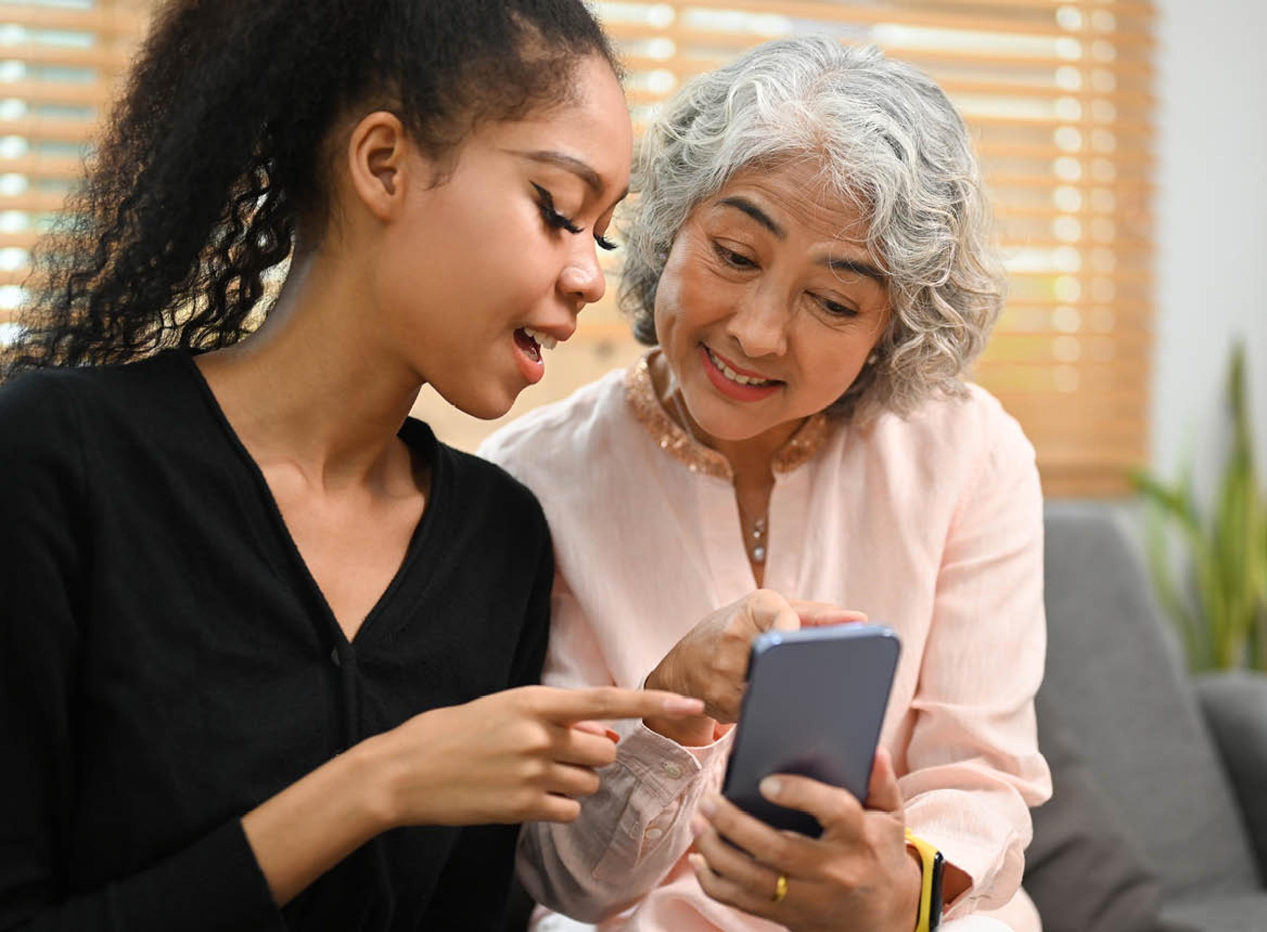 Two Women Looking at a Phone