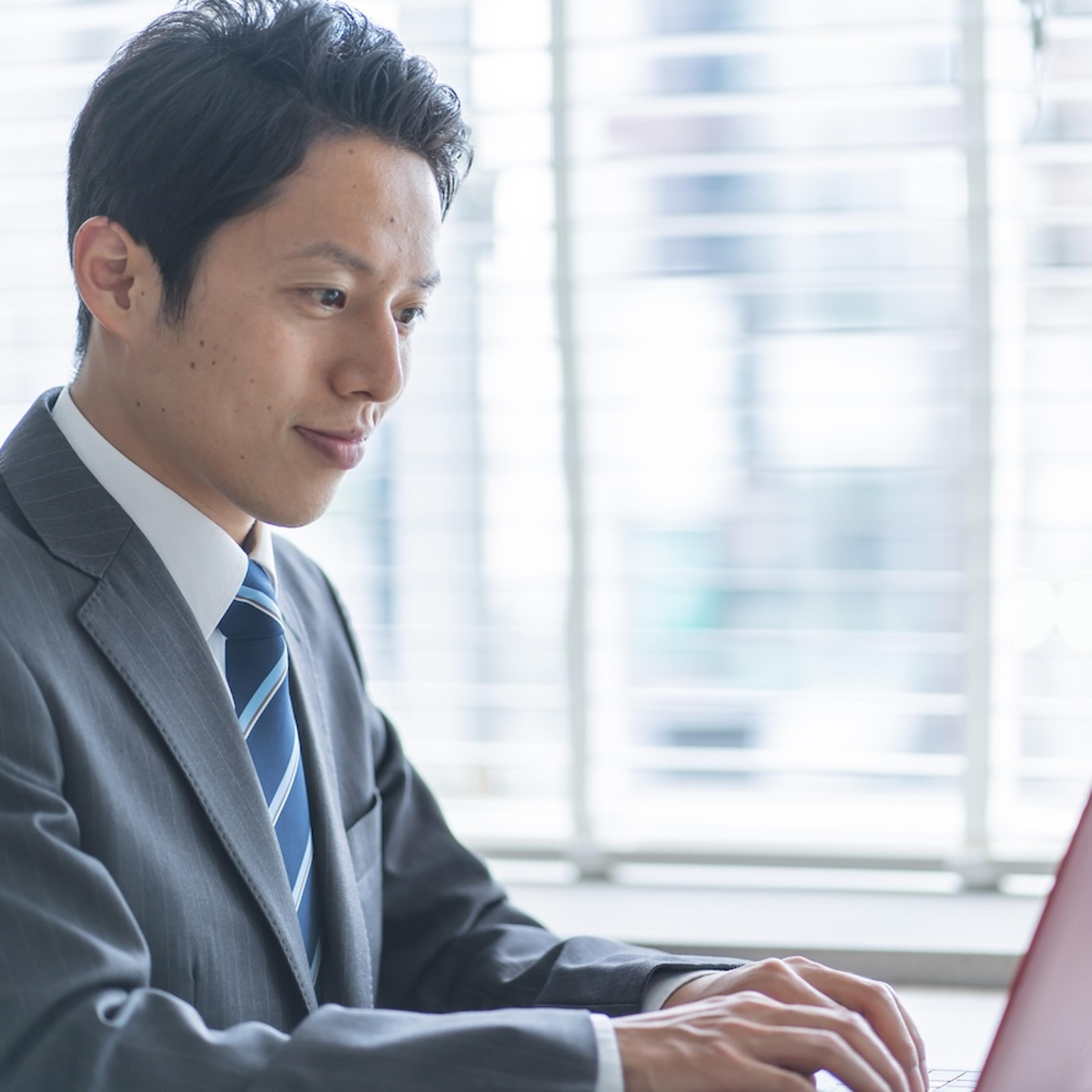 Asian Business Man Typing on Laptop
