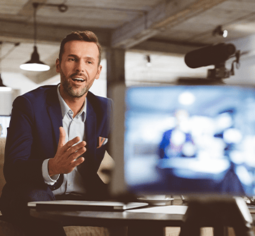 Man presenting webcast to screen