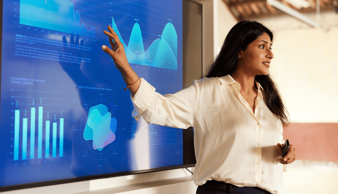 Woman Talking While Gesturing at a Graph