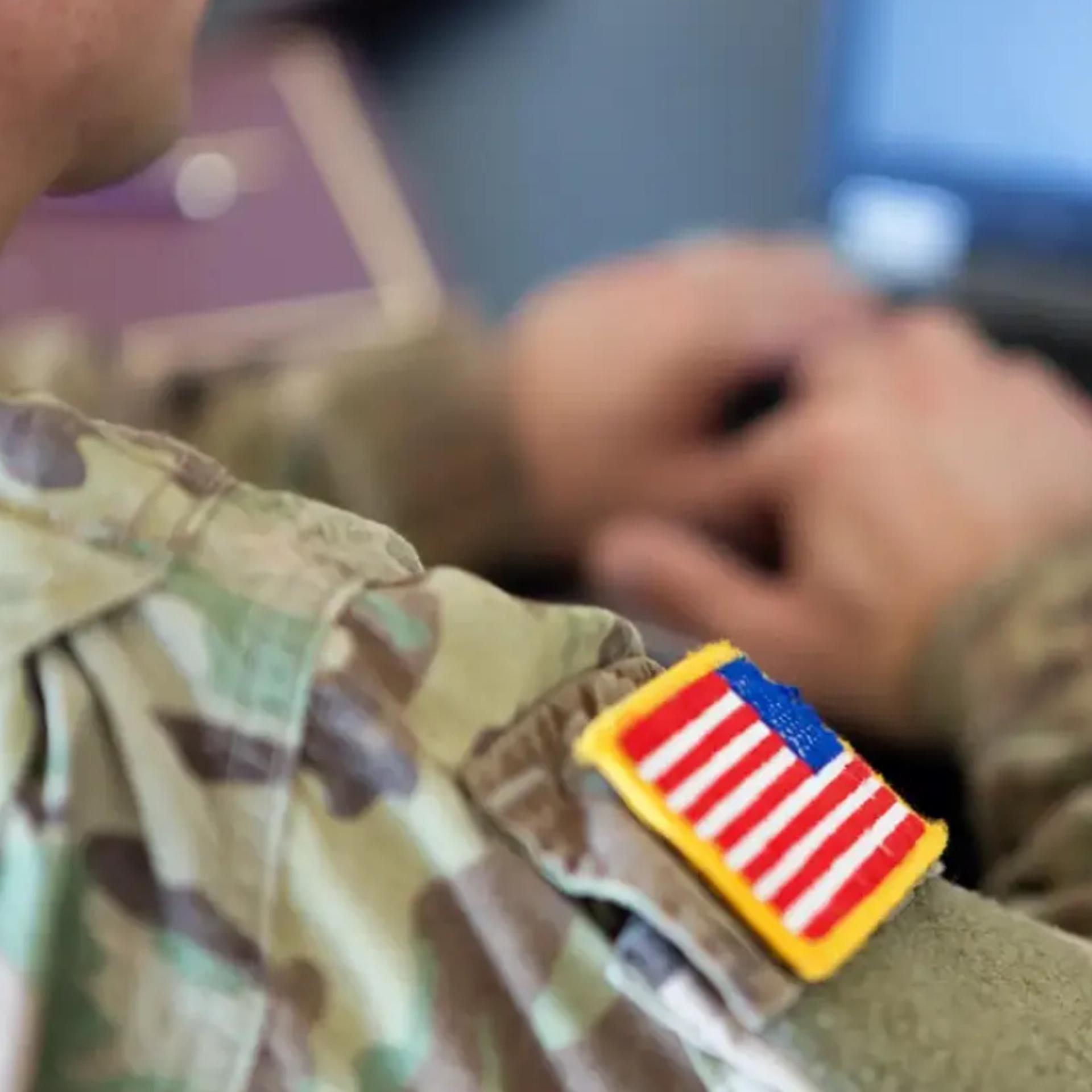 Soldier typing on laptop