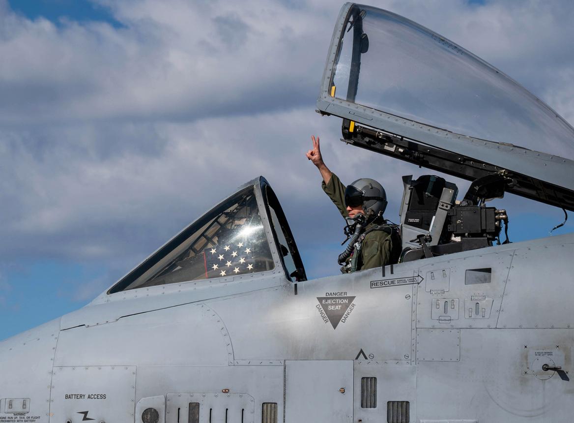 Pilot of Jet Fighter in Cockpit Holding Up Two Fingers