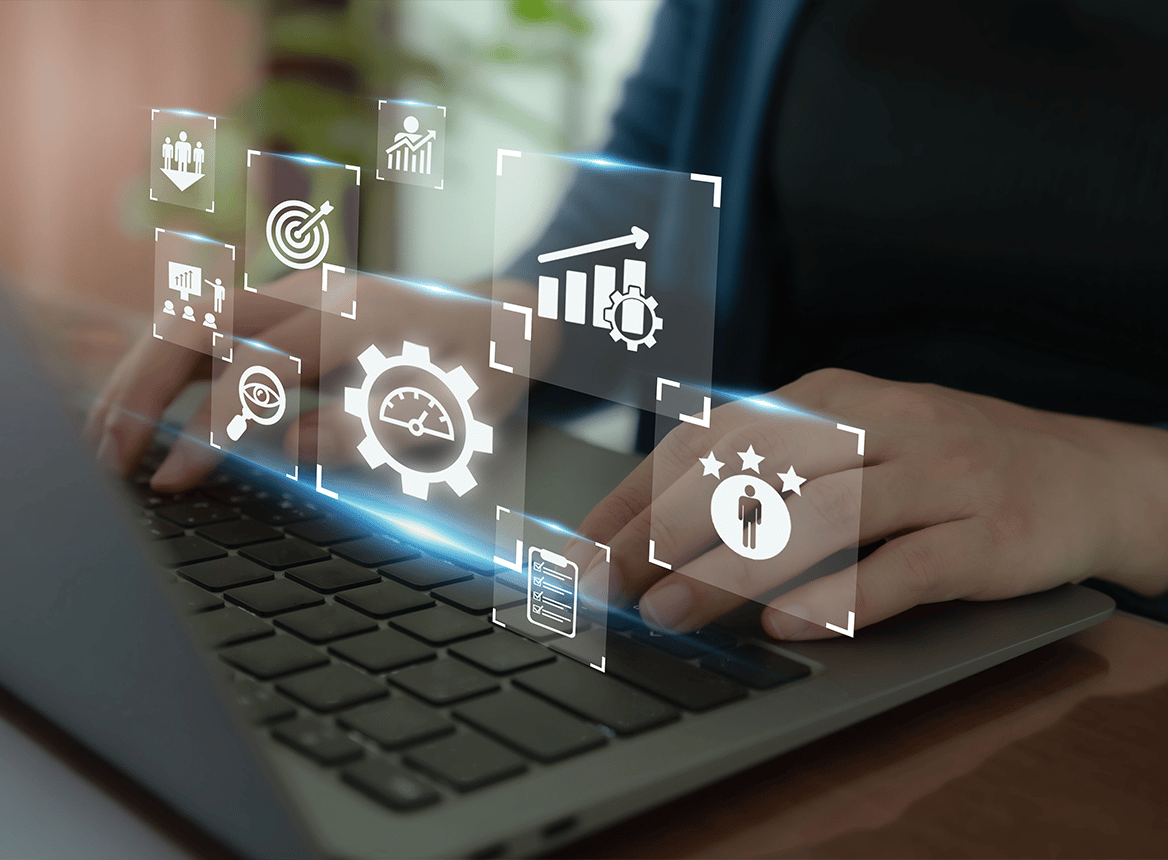 Person Typing on Laptop with Various Icons Floating Above the Hands