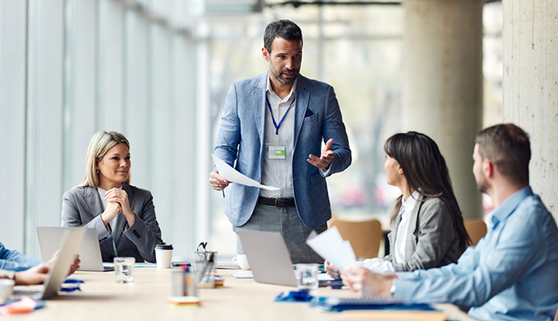 A Man Talking to Two Women in a Work Setting