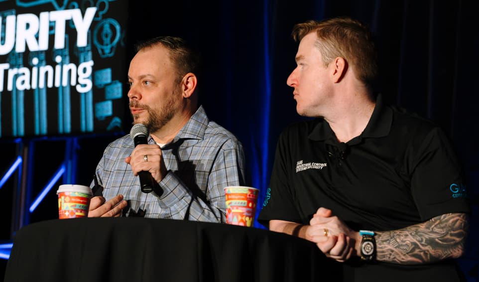 Two Speakers Talking on Stage