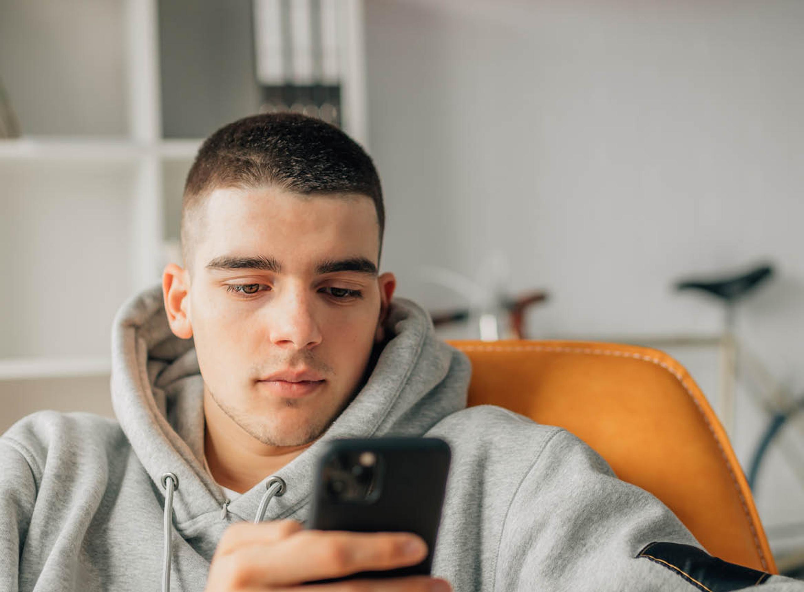 Split Content: Man Looking at His Phone: 1168x860