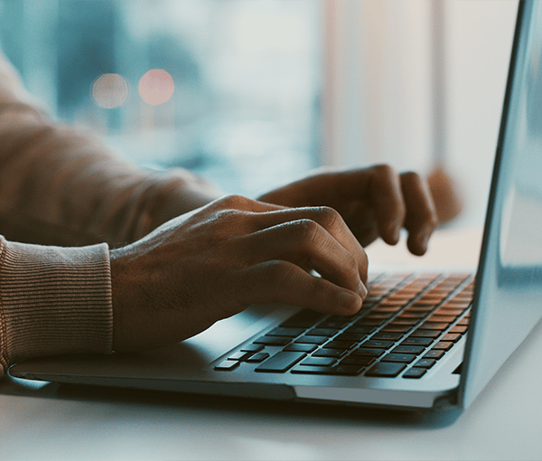 Hands Typing on Keyboard