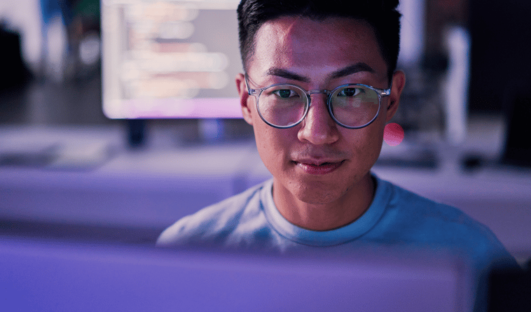 Close Up of Man Wearing Glasses and Looking at Computer