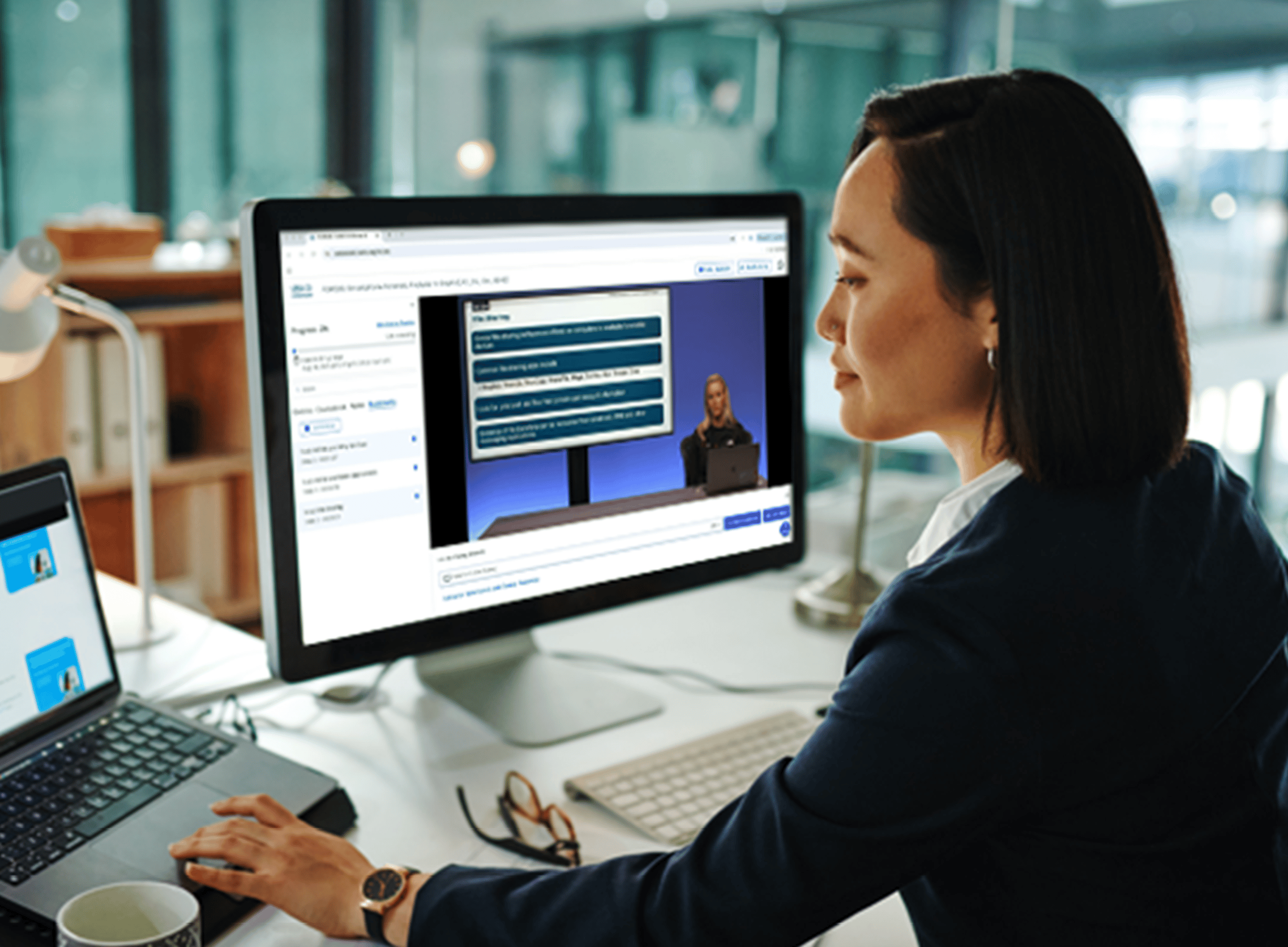 Woman Participating in Ondemand Training with Monitor Showing Training