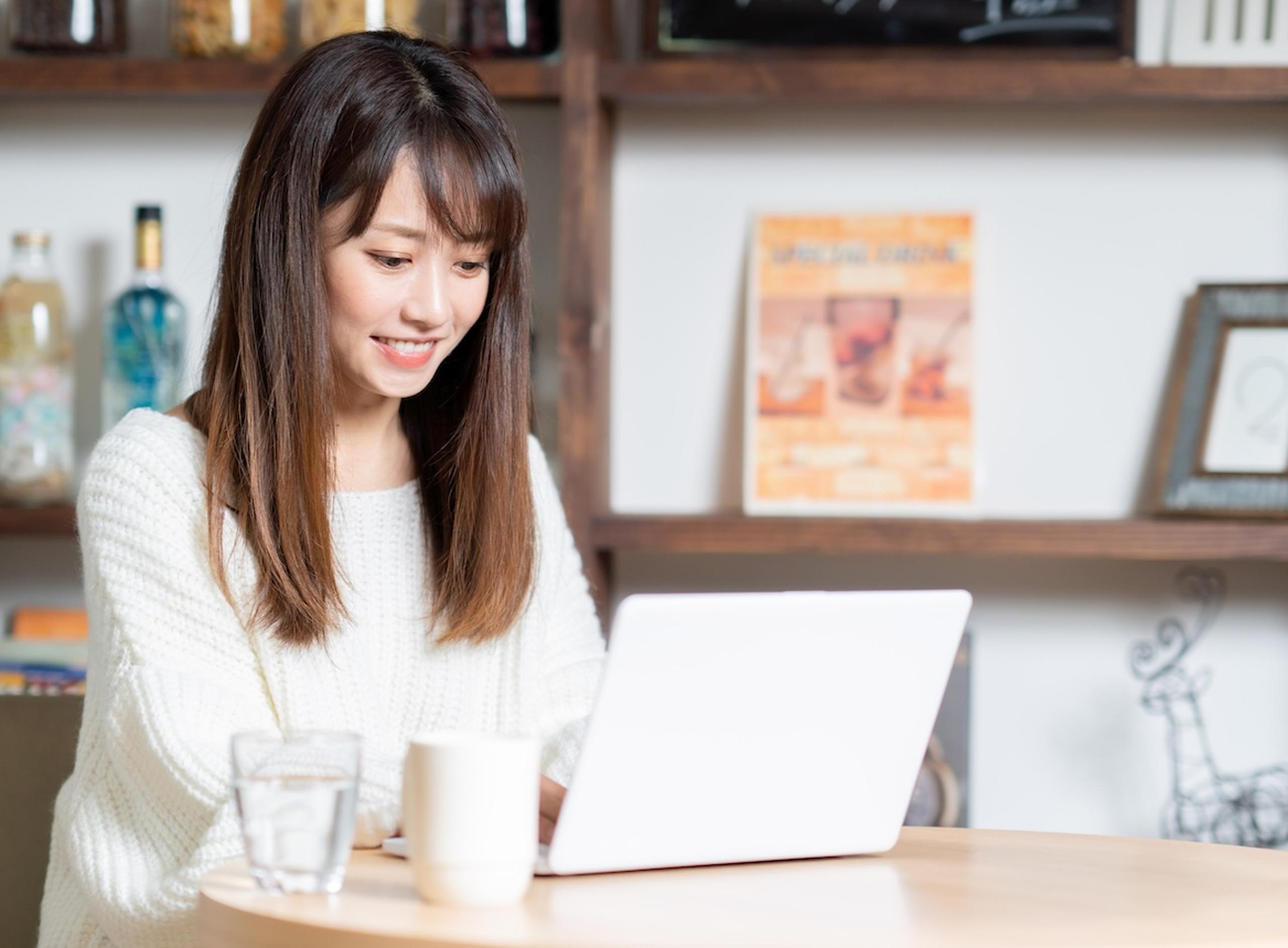 Asian Woman Typing on Laptop