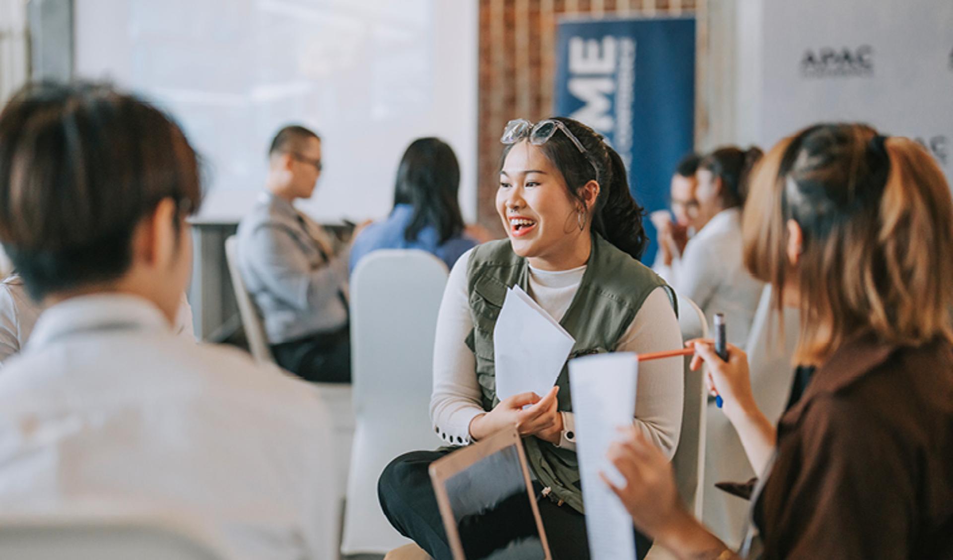 Woman Smiling in an APAC Event Room