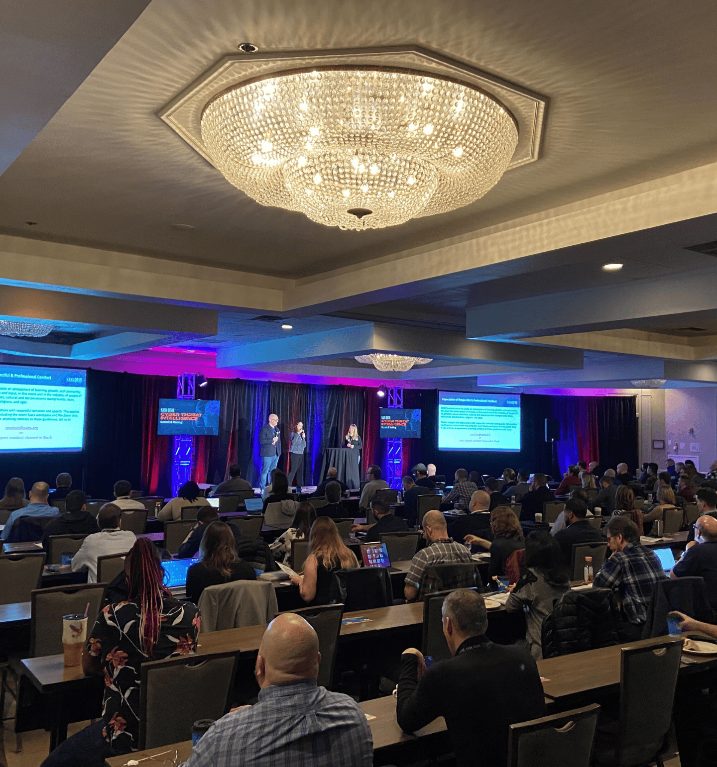 People on a Stage in a SANS Summit Room