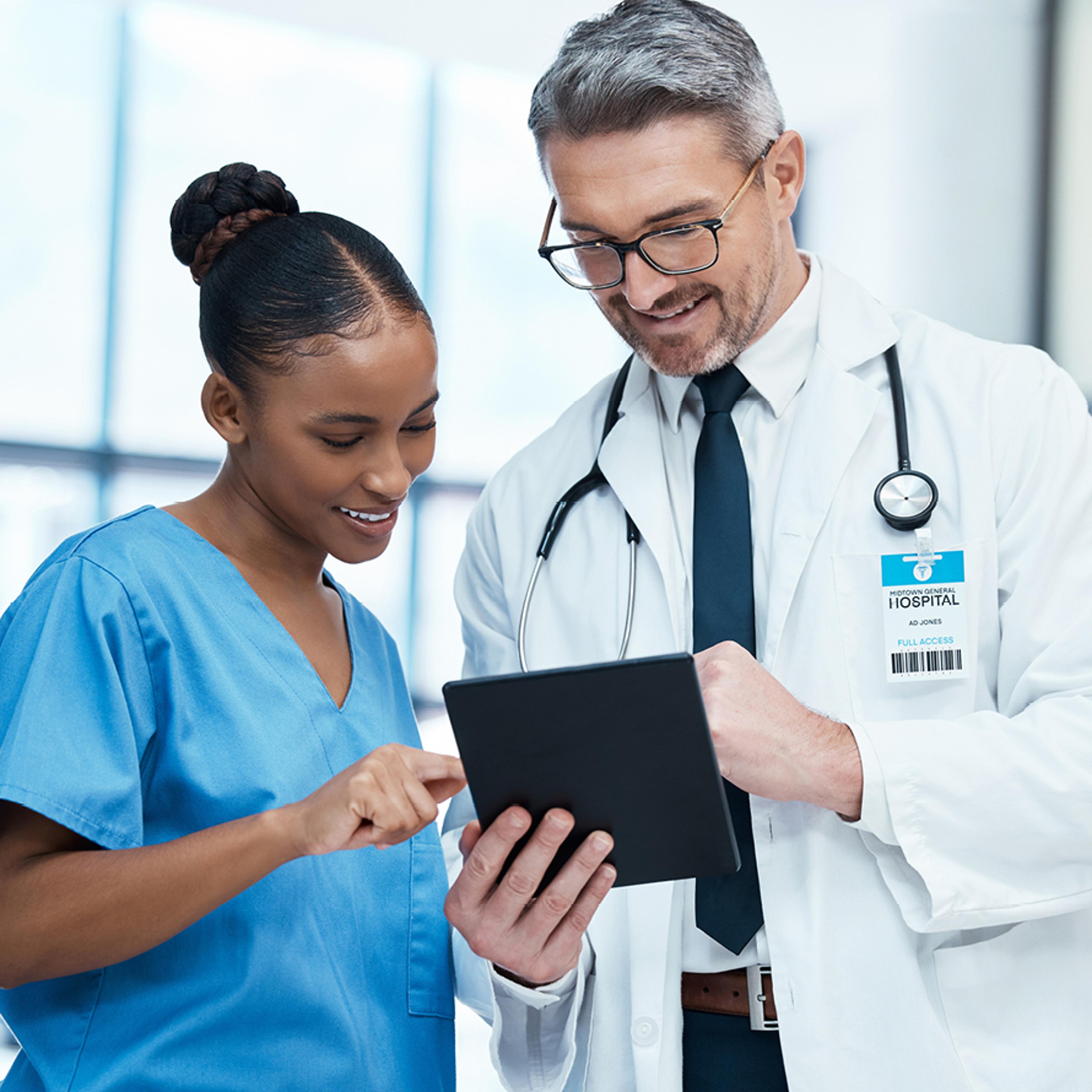 Nurse and Doctor Looking at a Tablet