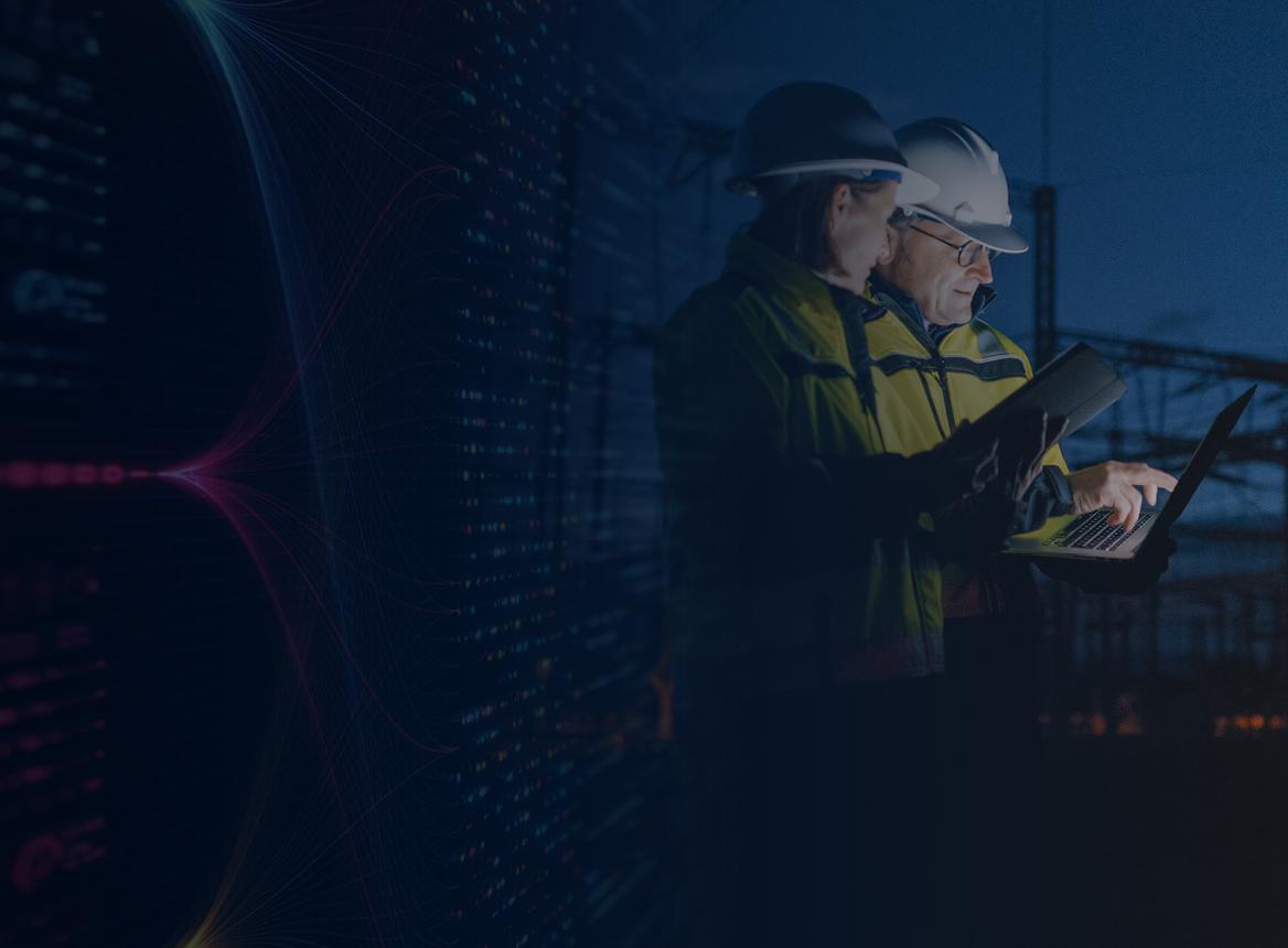 Two People in Hard Hats Looking at Computer