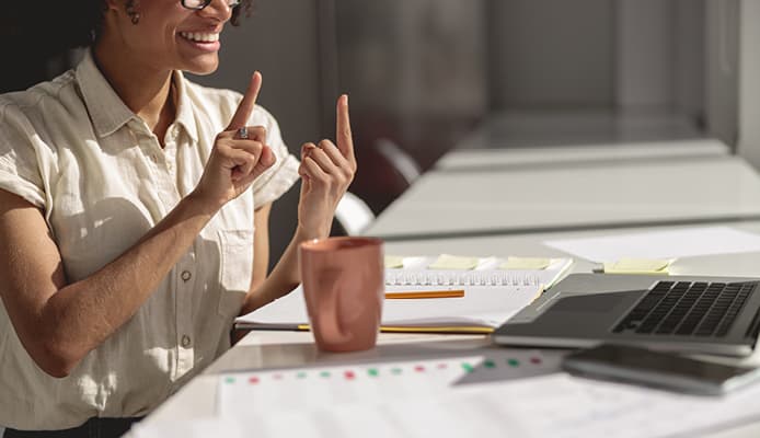 A Smiling Woman Using Sign Language