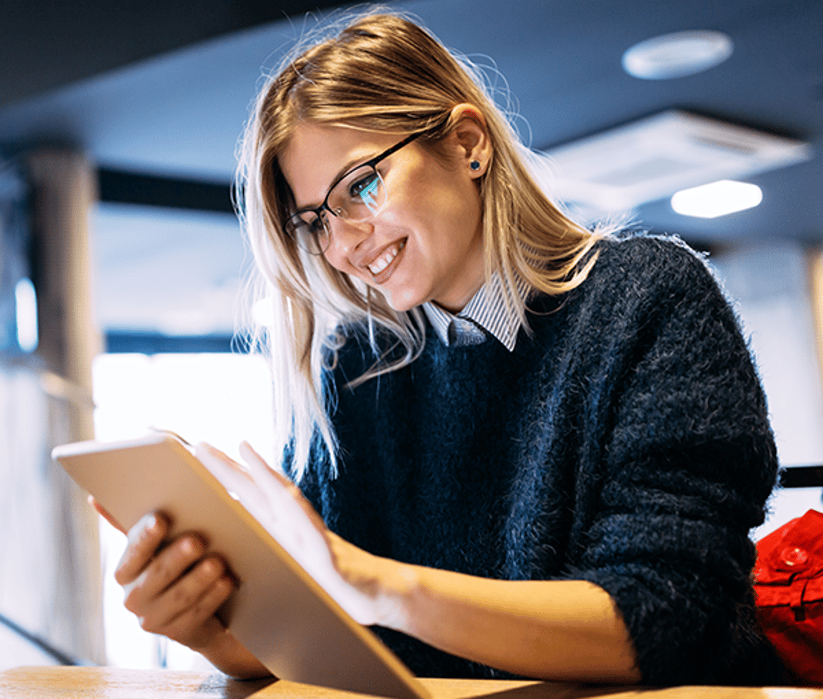 Woman smiling at tablet
